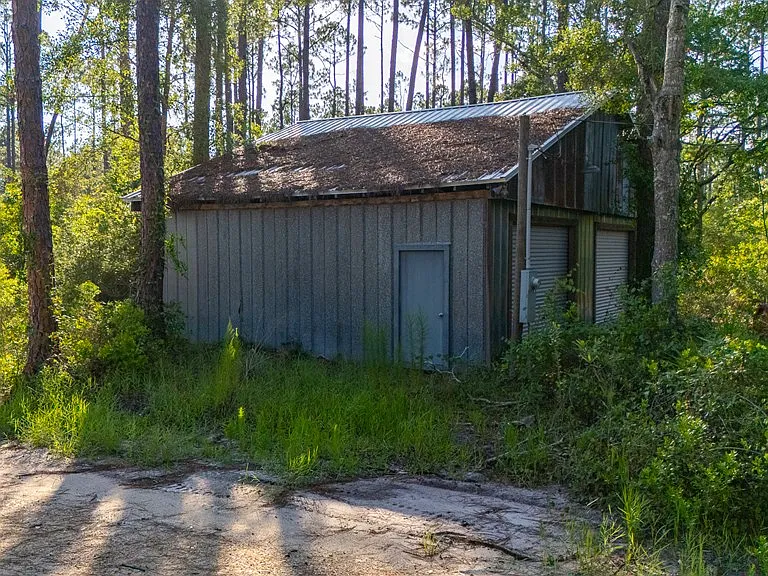 Doyle Creek Frontage on 10 Acres with Private Dock, Covered Boathouse, and Deep Shade Near Apalachicola