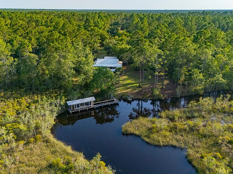 Doyle Creek Frontage on 10 Acres with Private Dock, Covered Boathouse, and Deep Shade Near Apalachicola