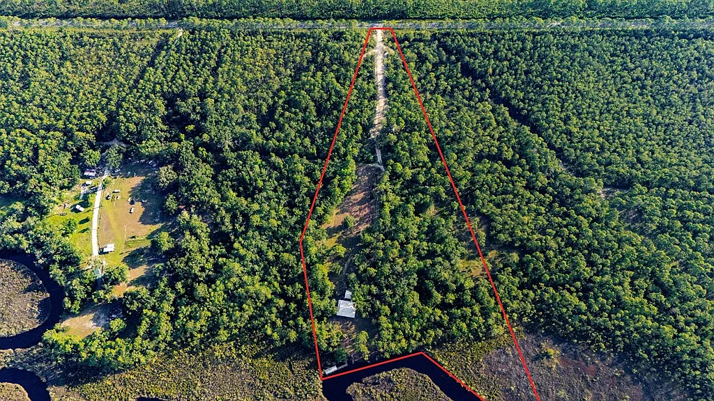 Doyle Creek Frontage on 10 Acres with Private Dock, Covered Boathouse, and Deep Shade Near Apalachicola