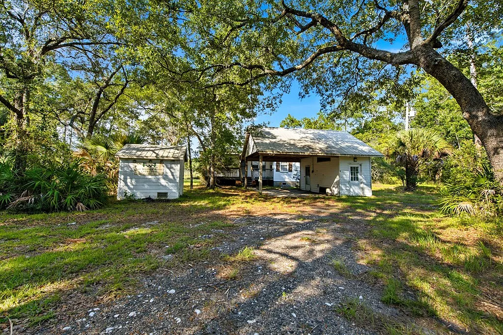 Doyle Creek Frontage on 10 Acres with Private Dock, Covered Boathouse, and Deep Shade Near Apalachicola