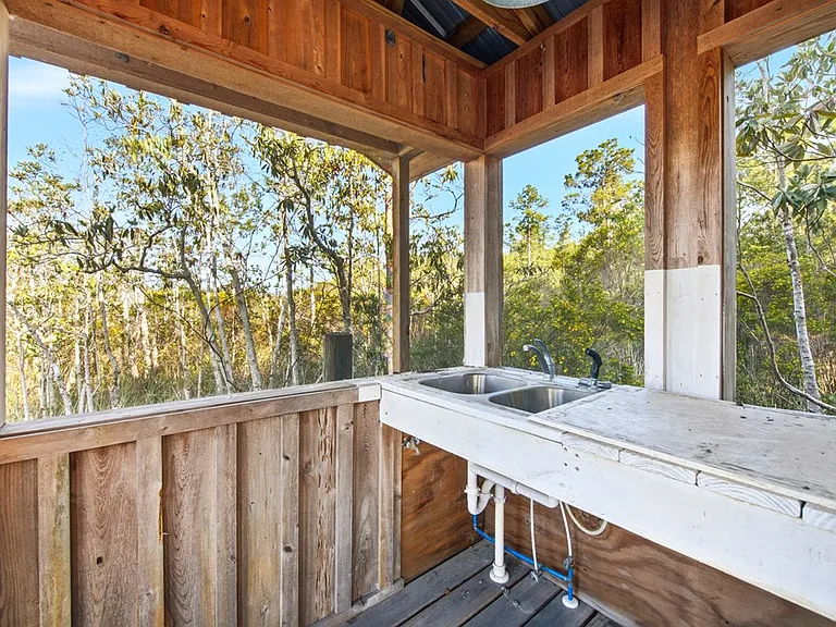 Doyle Creek Frontage on 10 Acres with Private Dock, Covered Boathouse, and Deep Shade Near Apalachicola