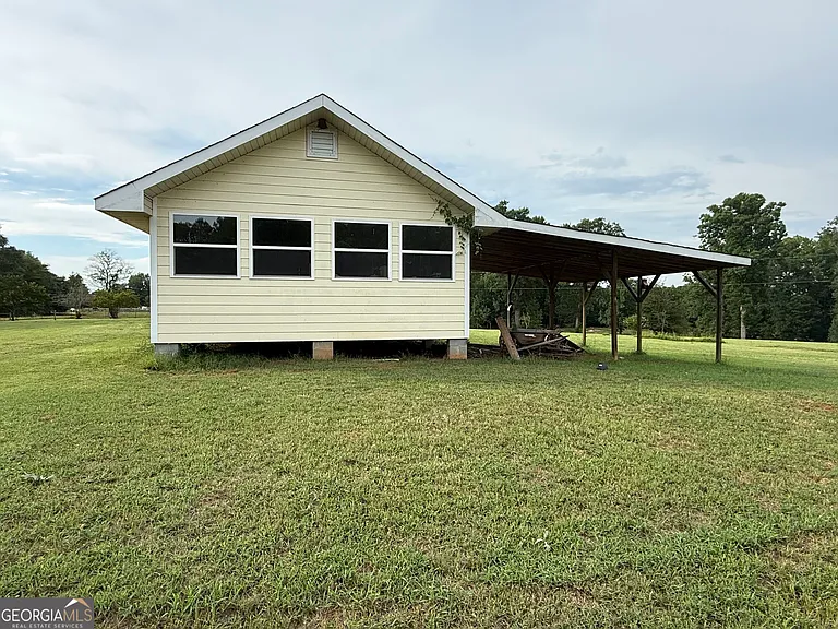 A Wraparound Porch With Grazing Cattle Next Door