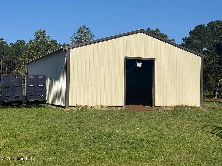 Turnkey Brick Farmhouse with Three Barns, Two Ponds, and 125 Acres Near McComb