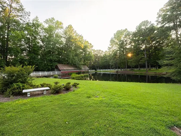 Custom Estate with Pond, Bridge Entrance, and Wooded Trails on 12 Acres Near I-95
