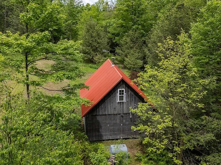 A Charming Cabin on 10 Wooded Acres Along a Babbling Stream