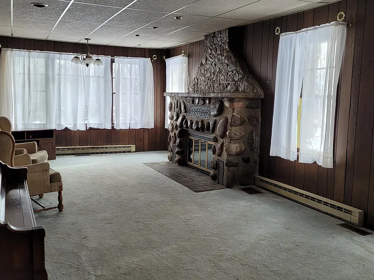 Three-Generation Stone Farmstead with Greenhouse, Barn, and Pond on 30 Acres Near Sault Sainte Marie