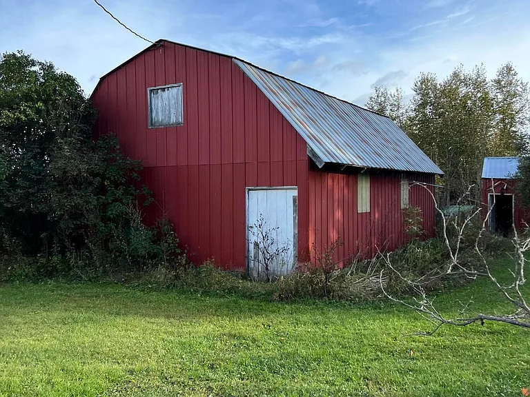 Three-Generation Stone Farmstead with Greenhouse, Barn, and Pond on 30 Acres Near Sault Sainte Marie