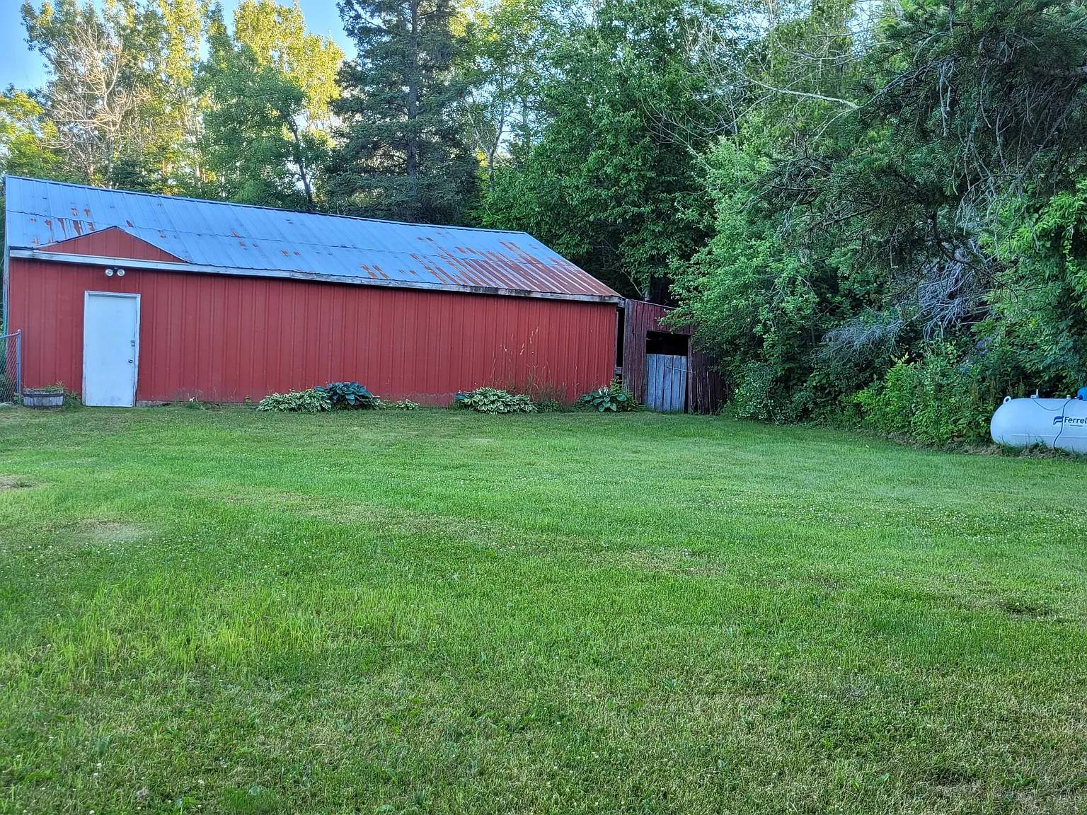 Three-Generation Stone Farmstead with Greenhouse, Barn, and Pond on 30 Acres Near Sault Sainte Marie