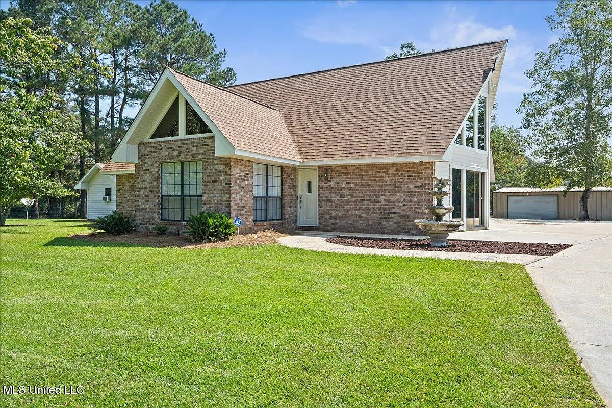 Turnkey Brick Farmhouse with Three Barns, Two Ponds, and 125 Acres Near McComb