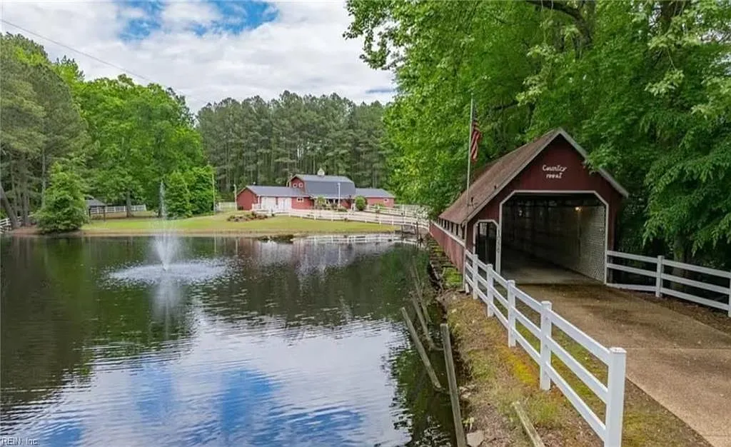Custom Estate with Pond, Bridge Entrance, and Wooded Trails on 12 Acres Near I-95