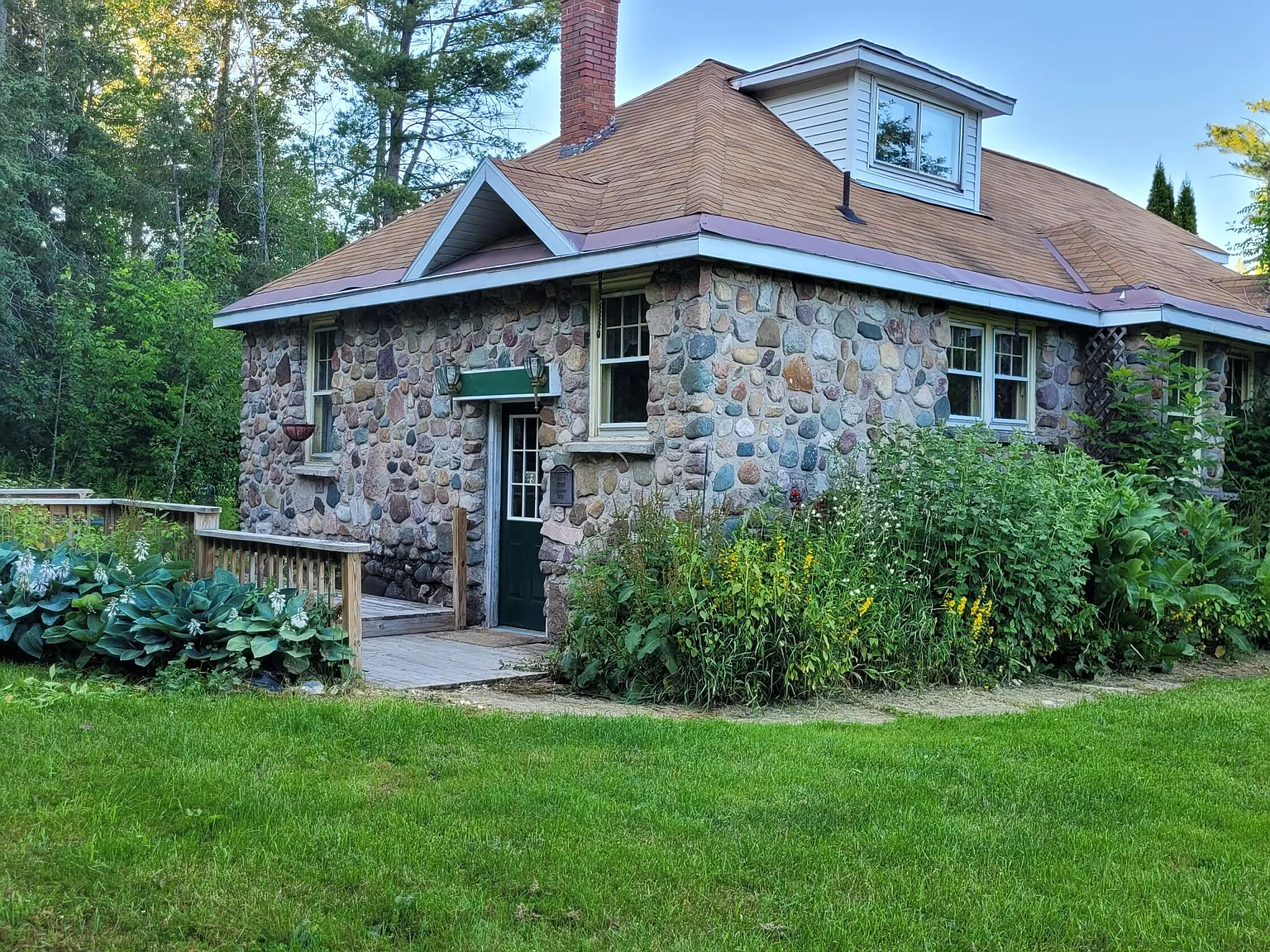 Three-Generation Stone Farmstead with Greenhouse, Barn, and Pond on 30 Acres Near Sault Sainte Marie